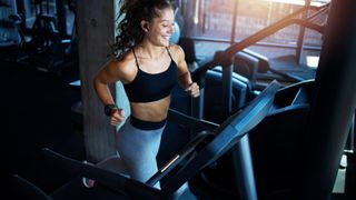 Woman running on a treadmill in a gym 