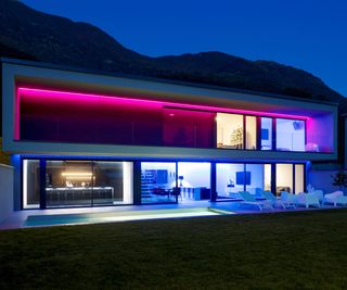 Colorful rope lights under the eaves of a modern home