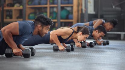 Group of people working out with dumbbells