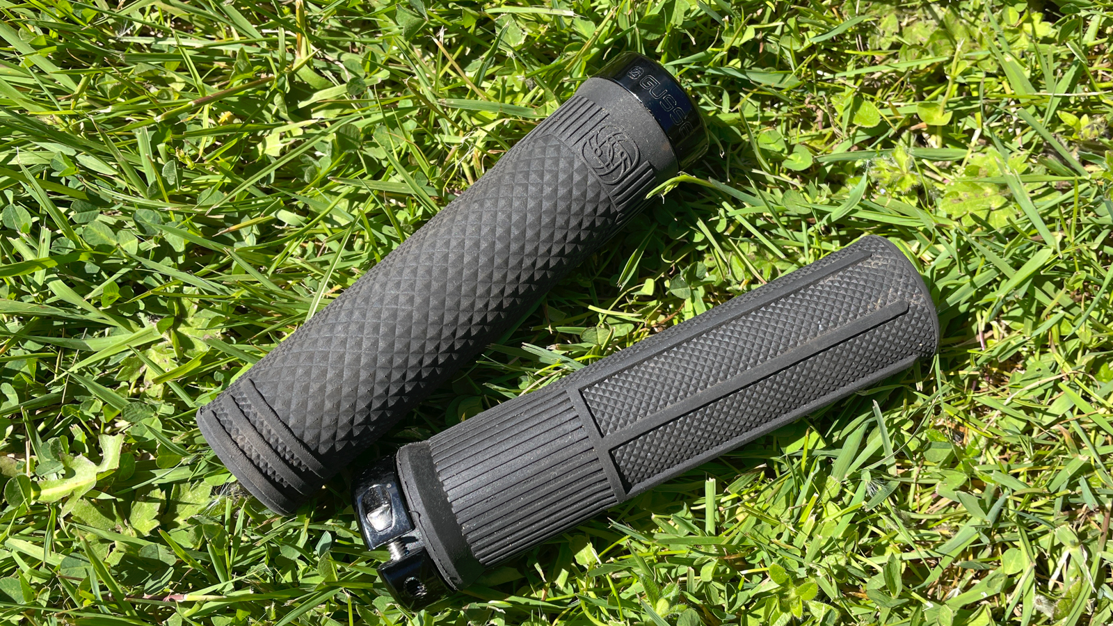 A pair of Gusset S2 Extra Soft Compound grips on some grass