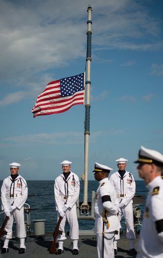 The American flag on the USS Philippine Sea (CG 58) is seen at half-mast during a burial at sea service for Apollo 11 astronaut Neil Armstrong, Friday, Sept. 14, 2012, in the Atlantic Ocean.