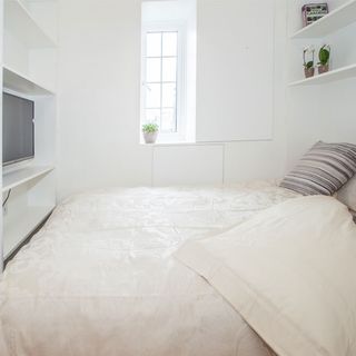 bedroom with white wall and tv