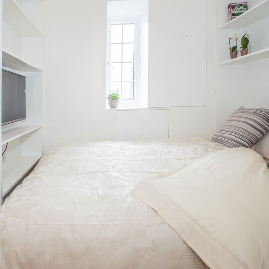 bedroom with white wall and tv