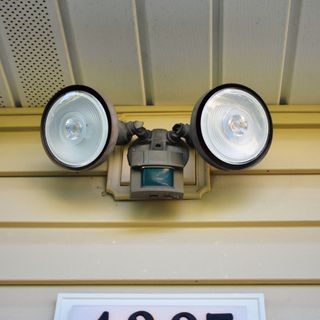 two floodlights on the outside of a house