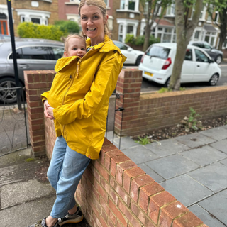 Our editor and tester, Anna Bailey, wearing the Wombat & Co Numbat Go Lightweight Babywearing Jacket