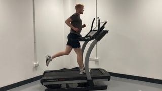 Image shows one of the best exercise machines to lose weight, a treadmill, being used by Live Science writer Harry Bullmore