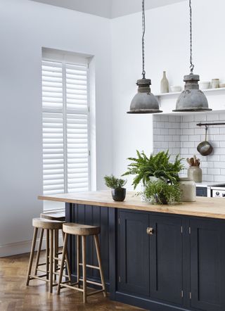 Window shutters at French doors in a kitchen by Shutterly Fabulous