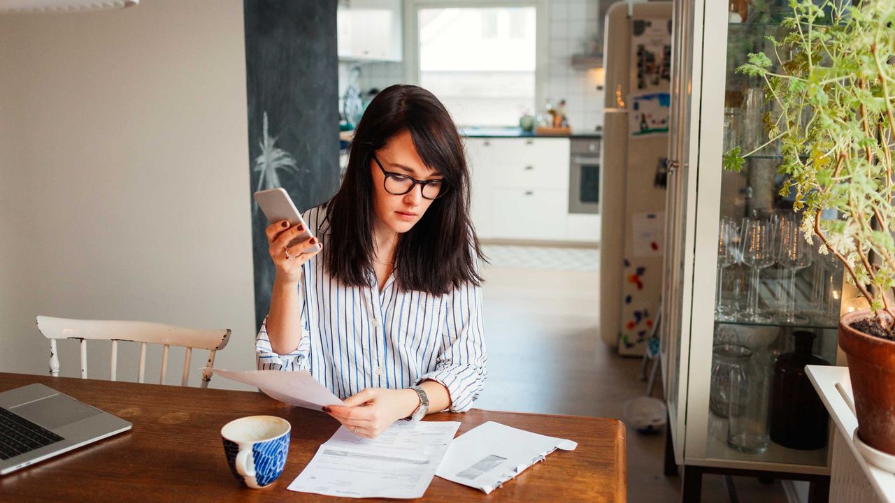 WOman goes through her budget at a desk