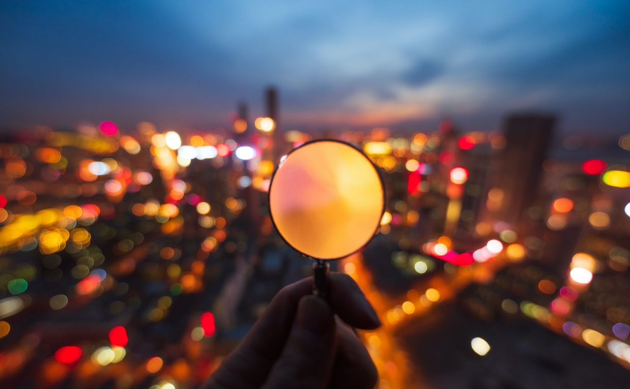 Observing the bustling city through magnifier