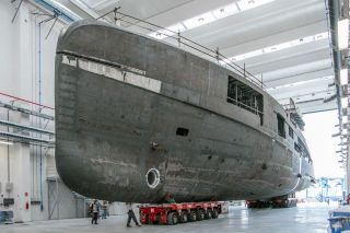 Inside a building at CRN's shipyard with an unfinished yacht in development.