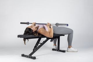 A woman performing a bench press