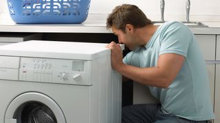 Man pulling out a washing machine