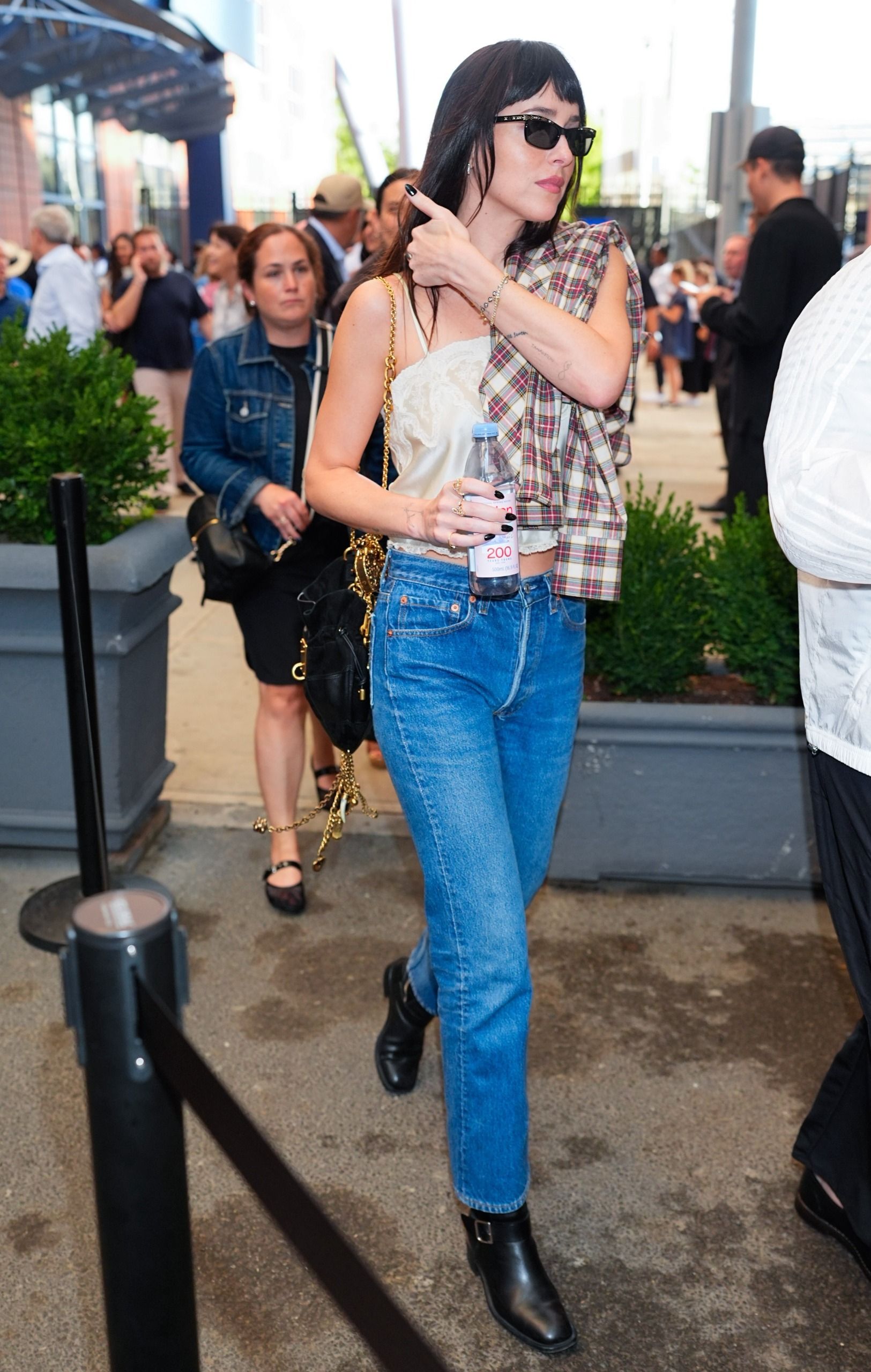 Dakota Johnson styled a flannel outfit for fall with jeans and a lace-trimmed camisole at the 2026 US Open
