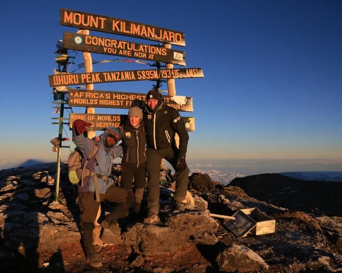 Soigneurs Peter de Connick and Lynda Cossard take a picture with their guide