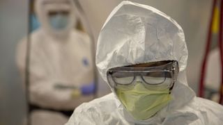 Caregivers in quarantine suits