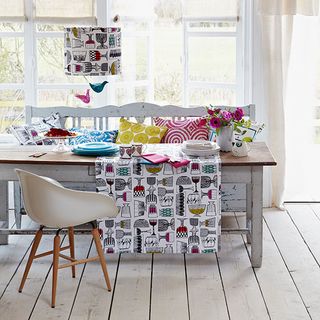dining table with colourful table cloths and cushions