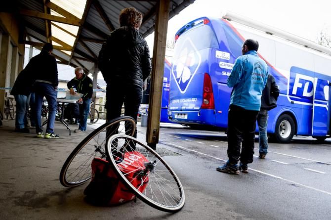 A team supporter prepares a wheelset and going to the course
