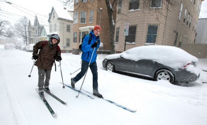 Two residents of Portland, Maine are seen skiing down the road during the early stages of snowstorm Nemo, Feb. 8.
