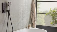 modern bathroom with black handheld shower head over bath