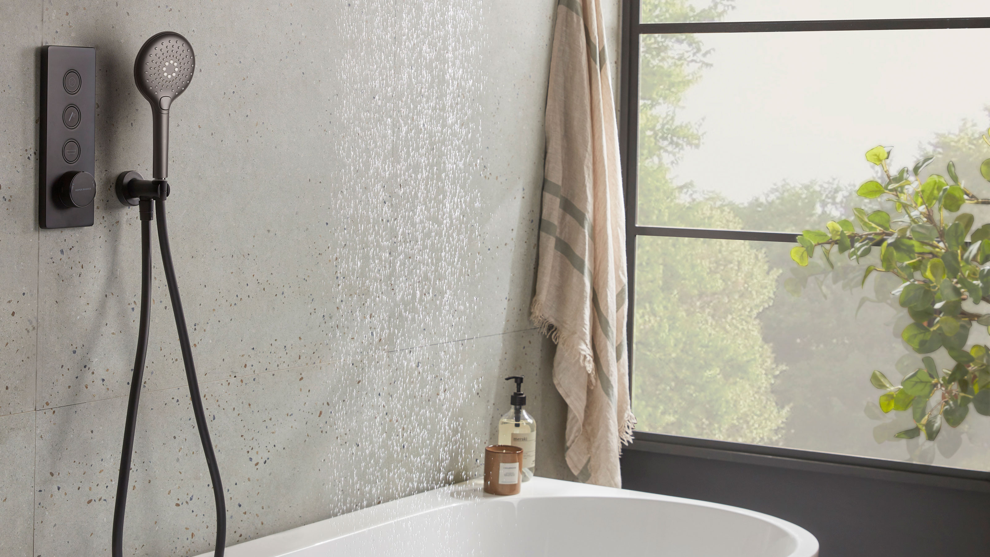 modern bathroom with black handheld shower head over bath