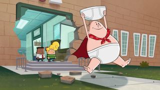 Captain Underpants running out of school holding a big pair of white pants.