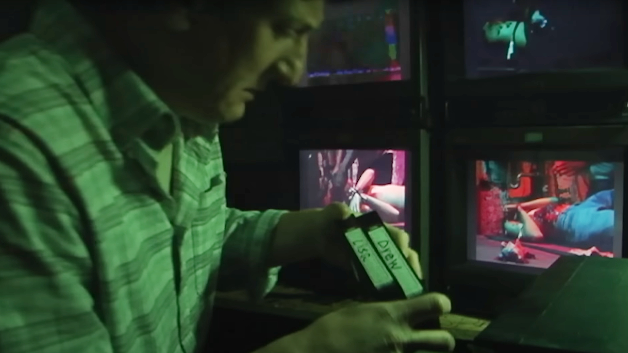 A man looking at VHS tapes in V/H/S/Halloween