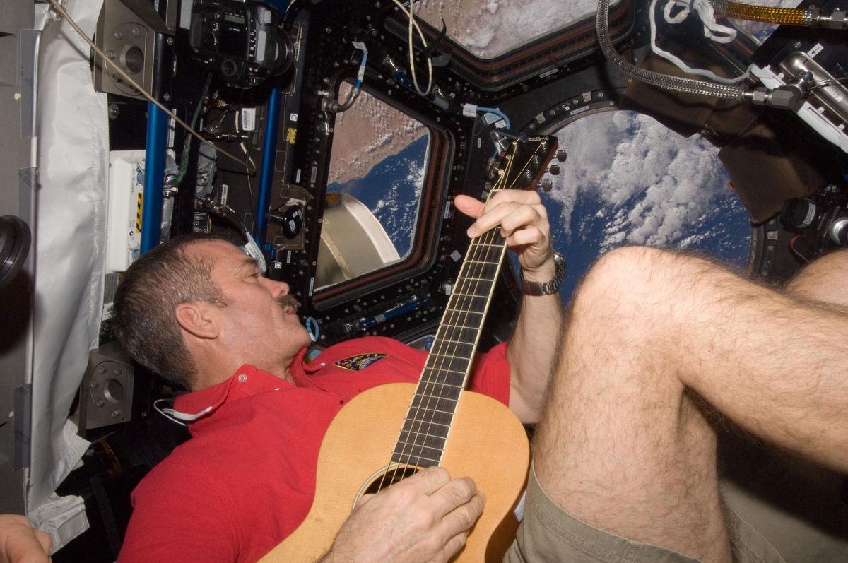 Hadfield playing guitar on the ISS