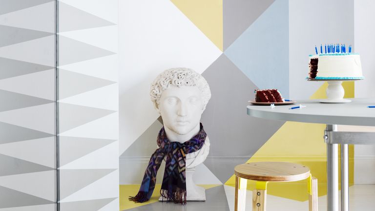 Mural trend styled in a modern home with grey and yellow interiors