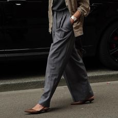 Woman in gray trousers and brown heels