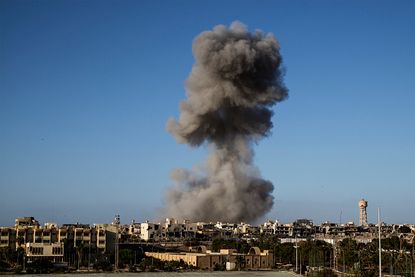 Smoke rises after an airstrike in Sirte, Libya.