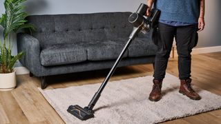 A black and gold Dreame R10 Pro cordless vacuum cleaner