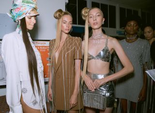 Area S/S 2019 models wear silver metallic bra and skirt, embellished brown