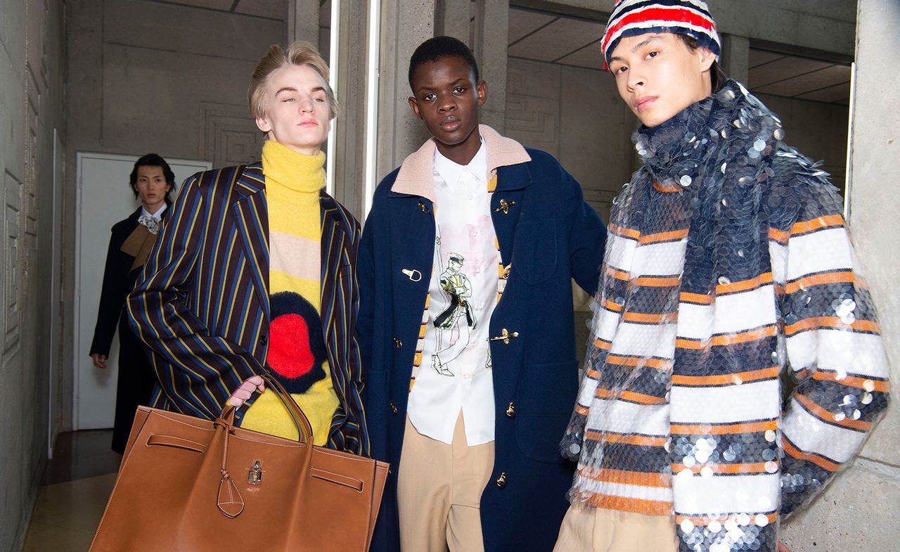 3 male models stood together in a studio 