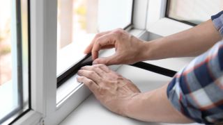 Man insulating a window
