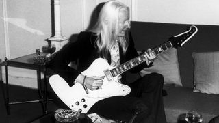 Johnny Winter plays a Gibson Firebird V in a hotel room, UK, 1974.