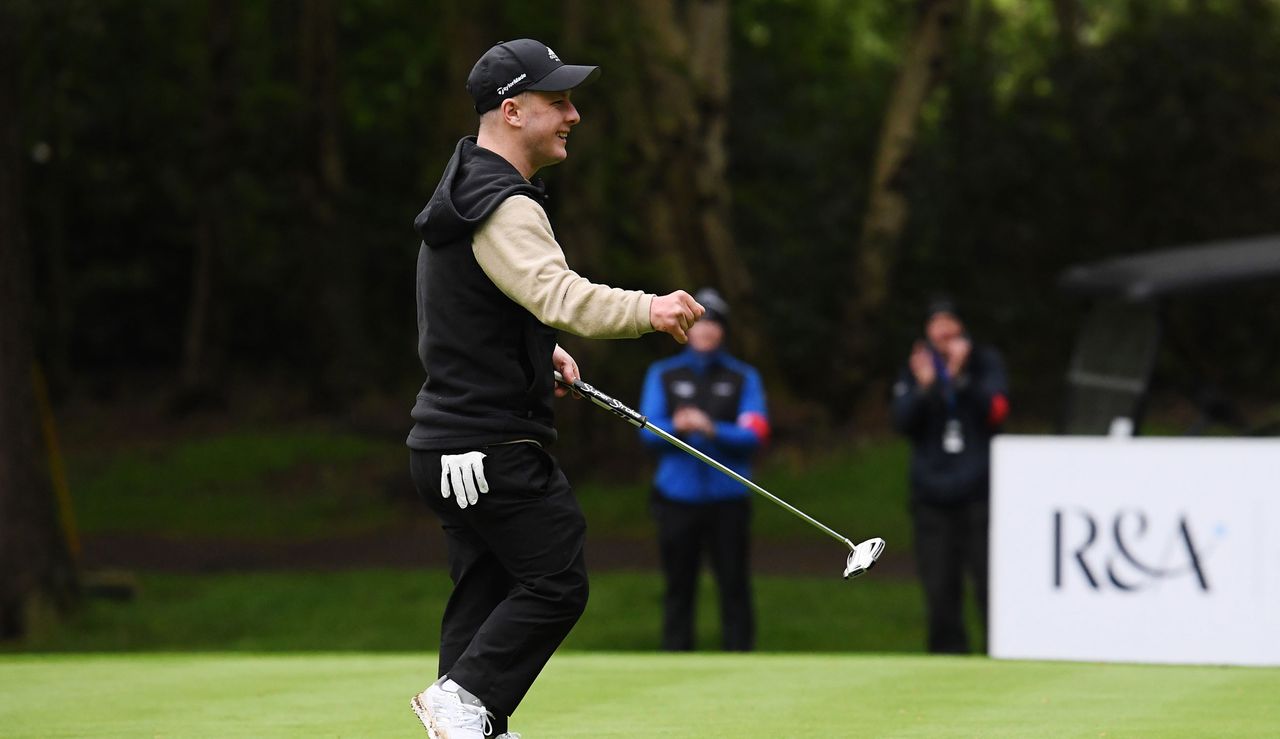 Brendan Lawlor waves to the crowd as he holes the winning putt