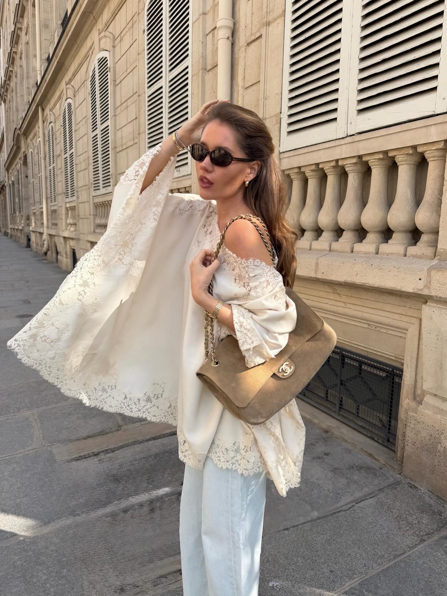 An image of a woman wearing a blouse and jeans summer outfit 2026