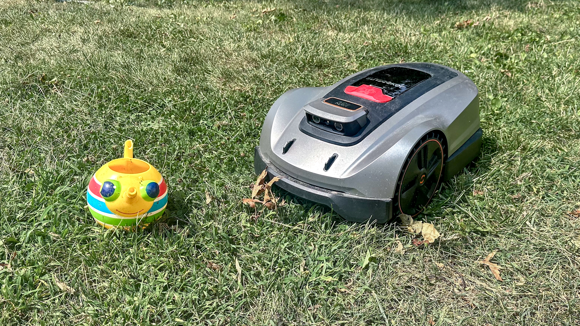 Sunseeker X3 Plus robot lawnmower avoiding childrens toy