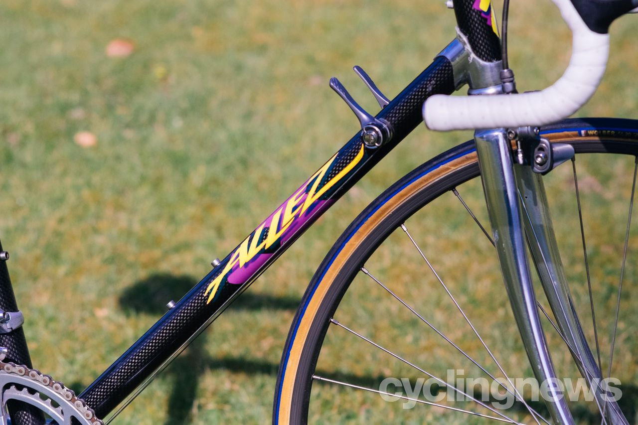 A black carbon tube with purple and yellow Allez logos