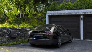 Tesla being charged at home using an electric car charging point