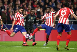 Liverpool’s Divock Origi is outnumbered in Madrid