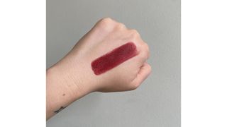Swatch of Charlotte Tilbury Limitless Lucky in Berry Happy red lipstick