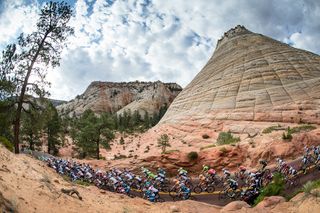 Larry H. Miller Tour of Utah - Stage 1 - The peloton passes by Checkerboard Mesa on its way out of Zion National Park