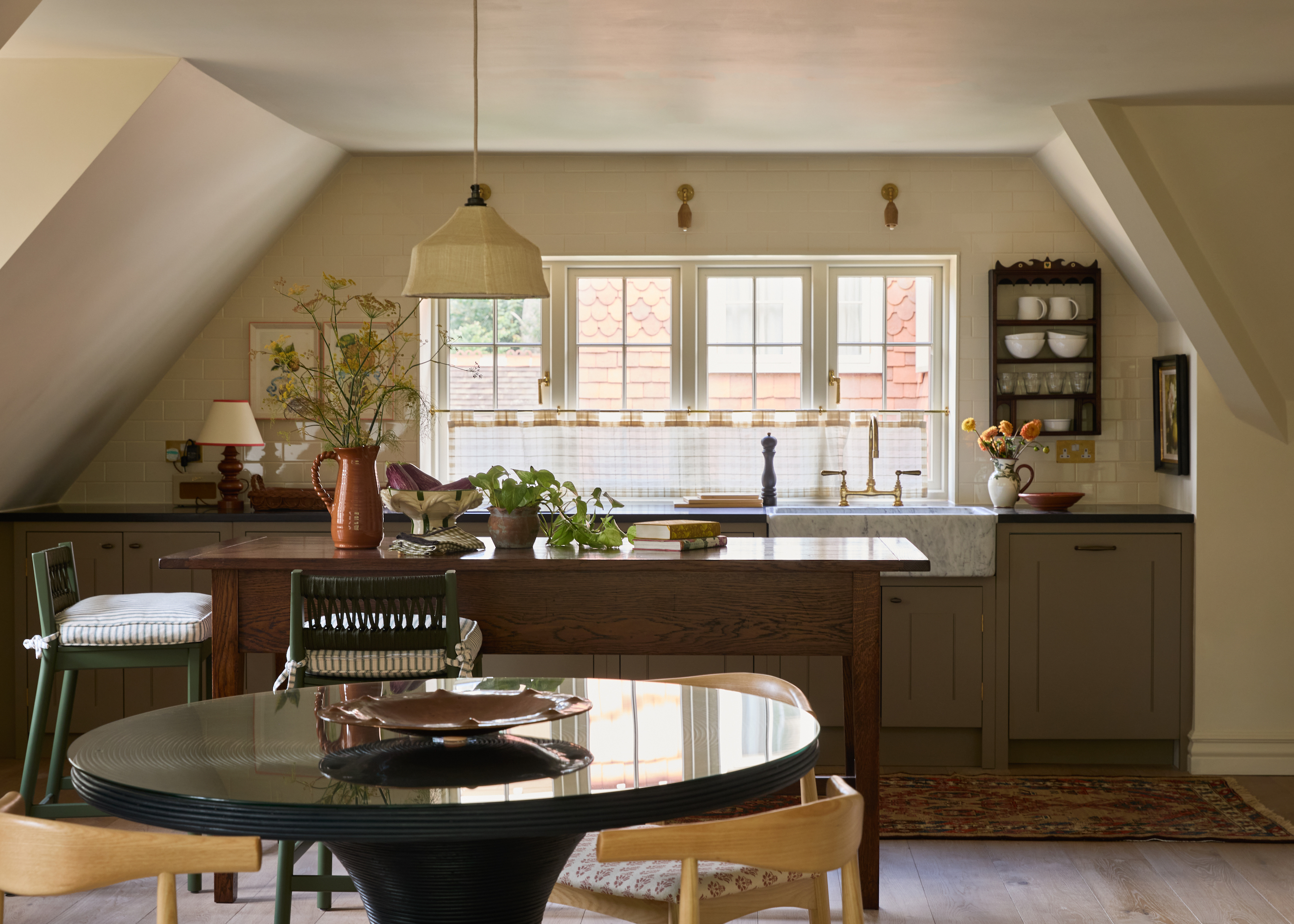brown kitchen with round dining table on a top floor of a building