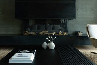Maple Place house's living room centred on dark modernist fireplace
