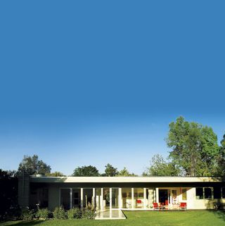 exterior of house with green lawn and blue sky