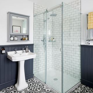 bathroom with white sink mirror and glass doors