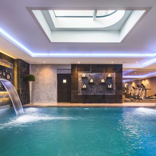 aspen house luxurious indoor swimming pool area complete with a waterfall and jacuzzi sauna steam room cinema room and a home gym