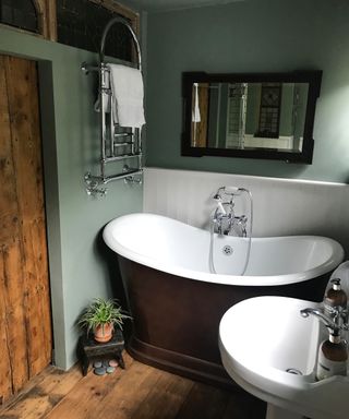 small metallic sided tub bath in bathroom