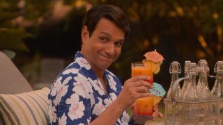 Ralph Macchio holding a drink in Cobra Kai on Netflix.